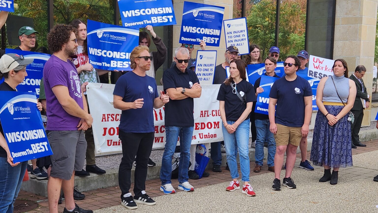 AFT/Wisconsin President Jon Shelton addresses union leaders from Universities of Wisconsin campuses with a group who are holding Wisconsin Deserves the Best signs and who attended the Board of Regents meeting.